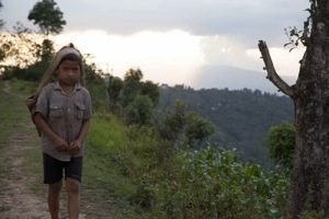 Dropping out to do other things: boy helping out on the farm