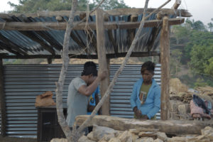 An emergency grant that got at least two months delayed: villagers setting up  a temporary shelter