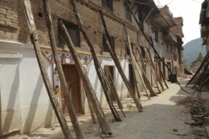Kept erect only by heavy timber beams: damaged Khokana houses