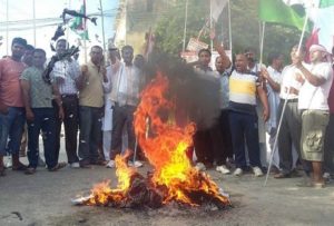 Protesters burning copies of the draft constitution while local economy is losing millions every day