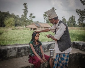 Witchdoctor driving out an evil spirit of a "possessed" village girl: dangerous craft if instead locals feel spells are cast on them!